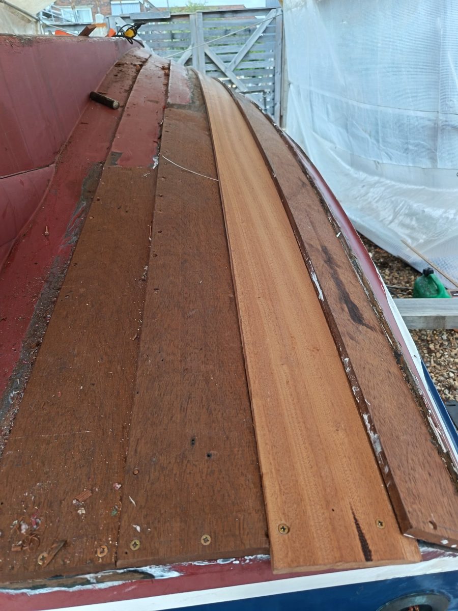 Close view along Bunny's bottom showing the new plank screwed in place beside the original planking