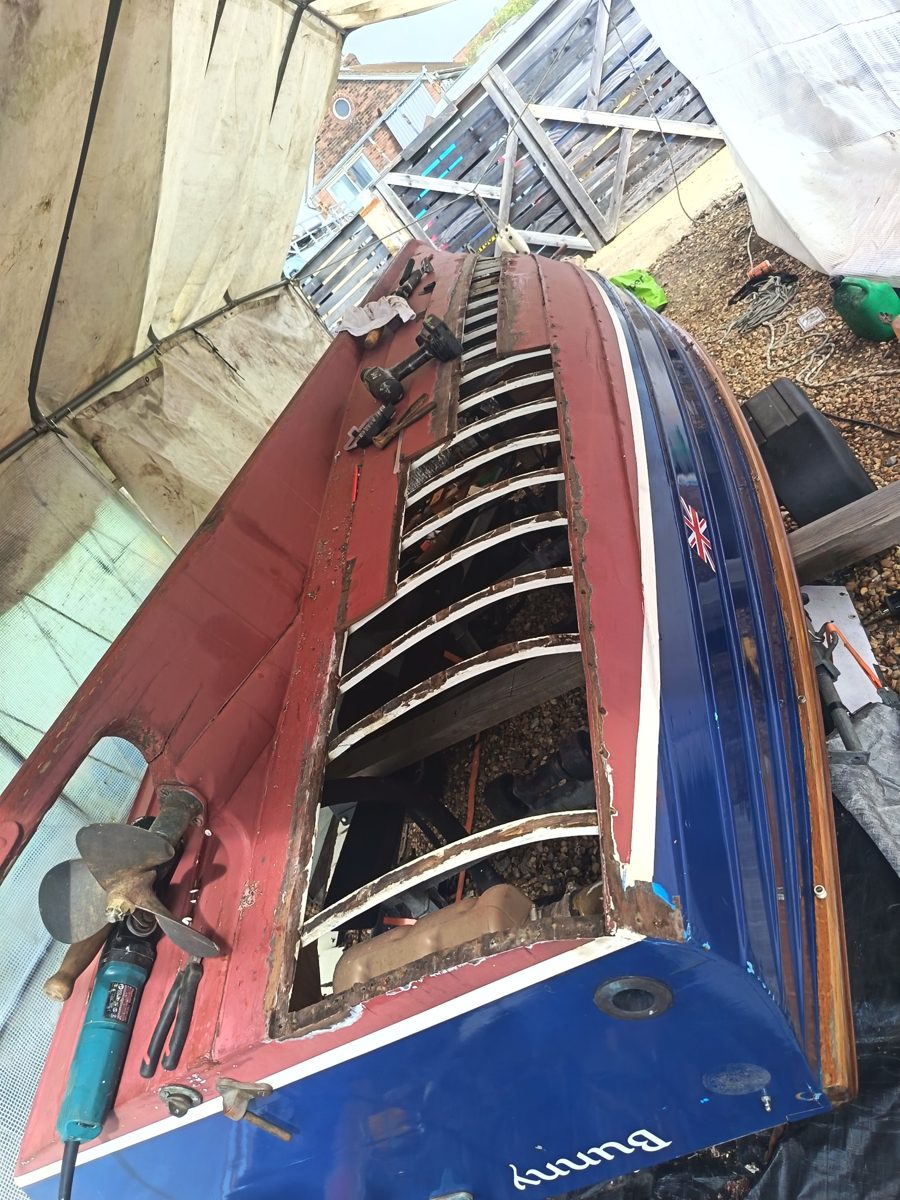 Bunny upturned with damaged planks removed, exposing the frames from the transom forward