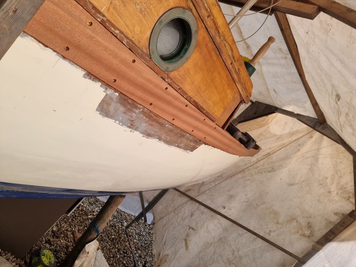 New plank fitted along the sheer beneath the cabin side, fastening holes ready to be plugged