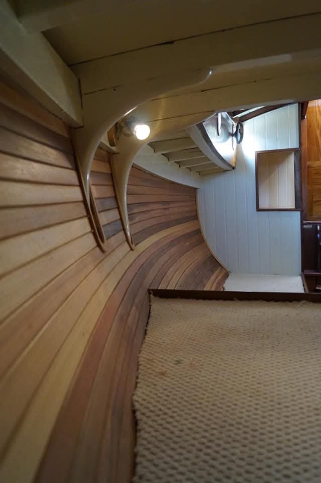 Curved cabin ceiling planking and painted knees along the hull side