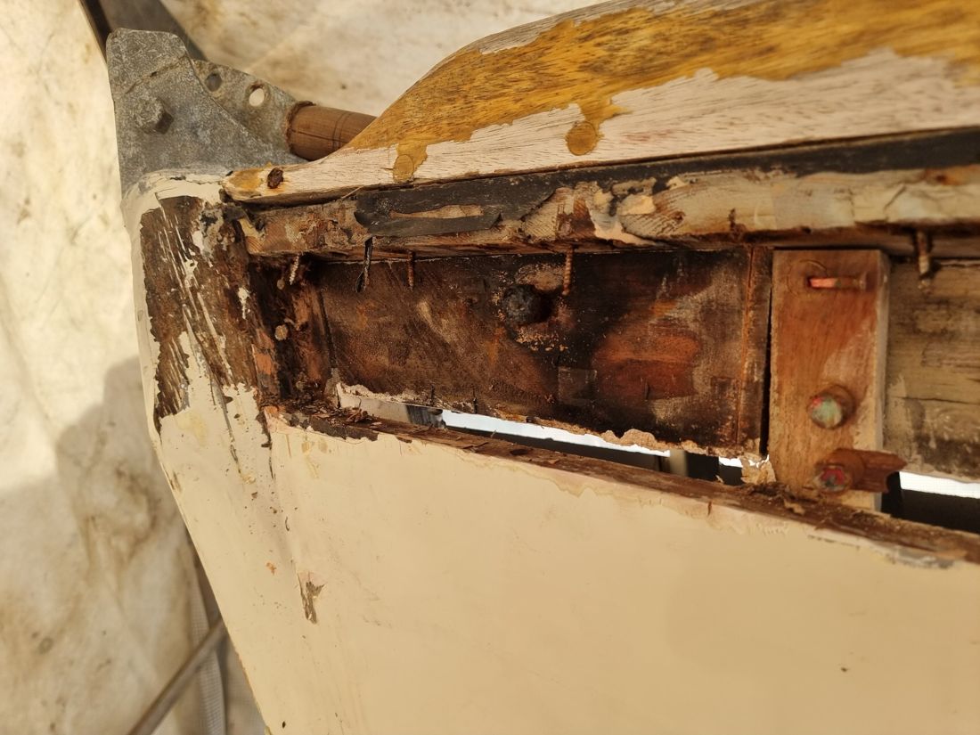 Opened-up sheer at the stern revealing rotten timber, corroded fastenings and a hole through to daylight
