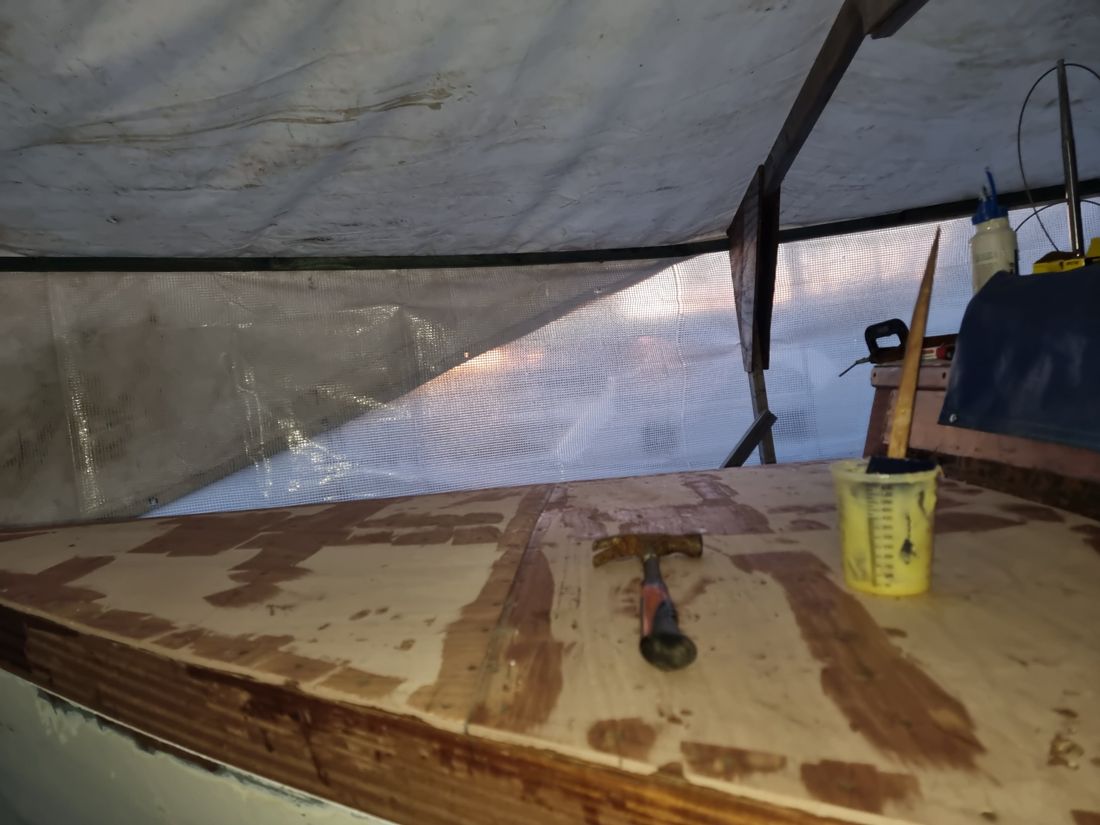 New ply deck laid and glued, with a hammer and glue pot on top