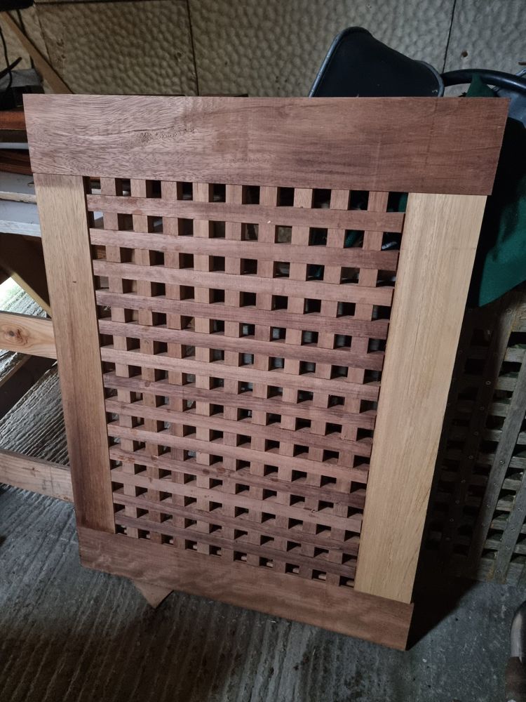 Finished hardwood cockpit grating with a solid frame around the lattice