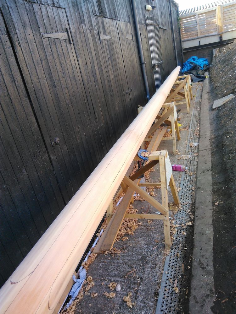 Mast planed fully round and tapered, resting on trestles