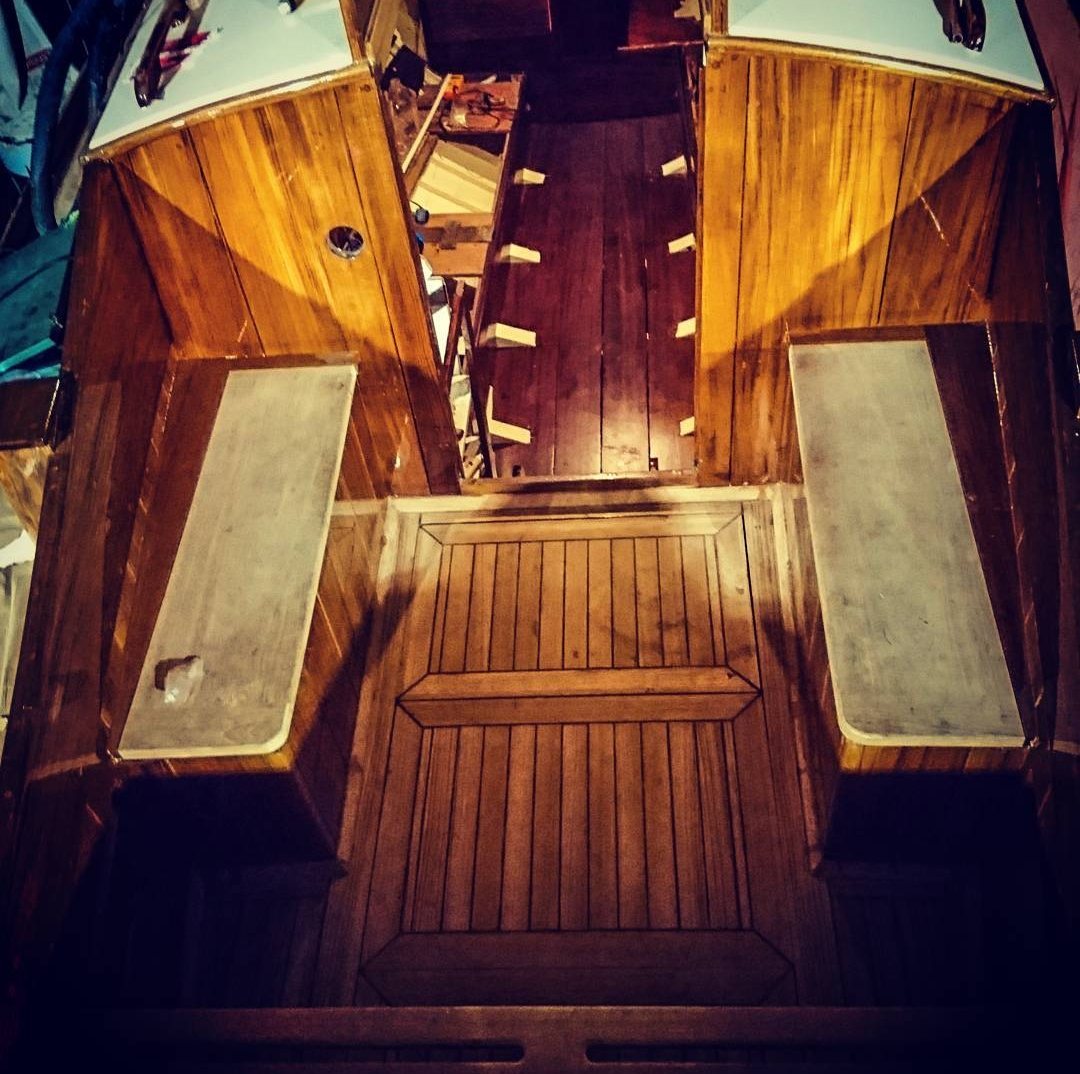 Roamer's new cockpit seen from above, with seats, varnished coamings and the companionway steps beyond