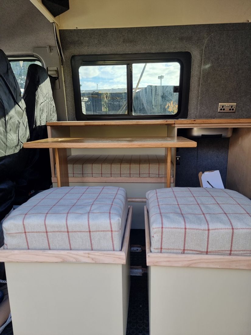 Dinette with bench seat, oak table and two cushioned storage stools