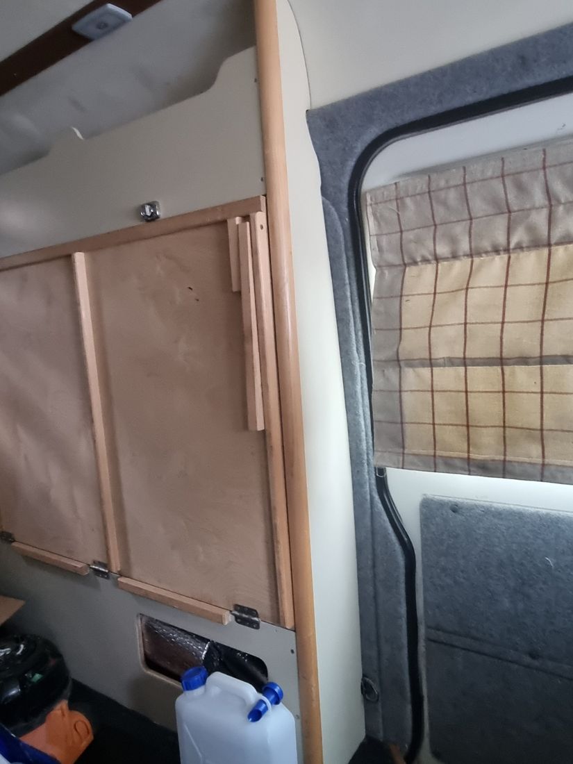 Window seat with checked cushions under an oak sill