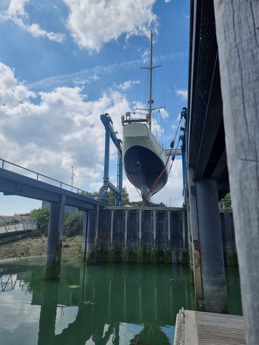 Zircon lowered into the dock by the travel hoist, seen from the water below