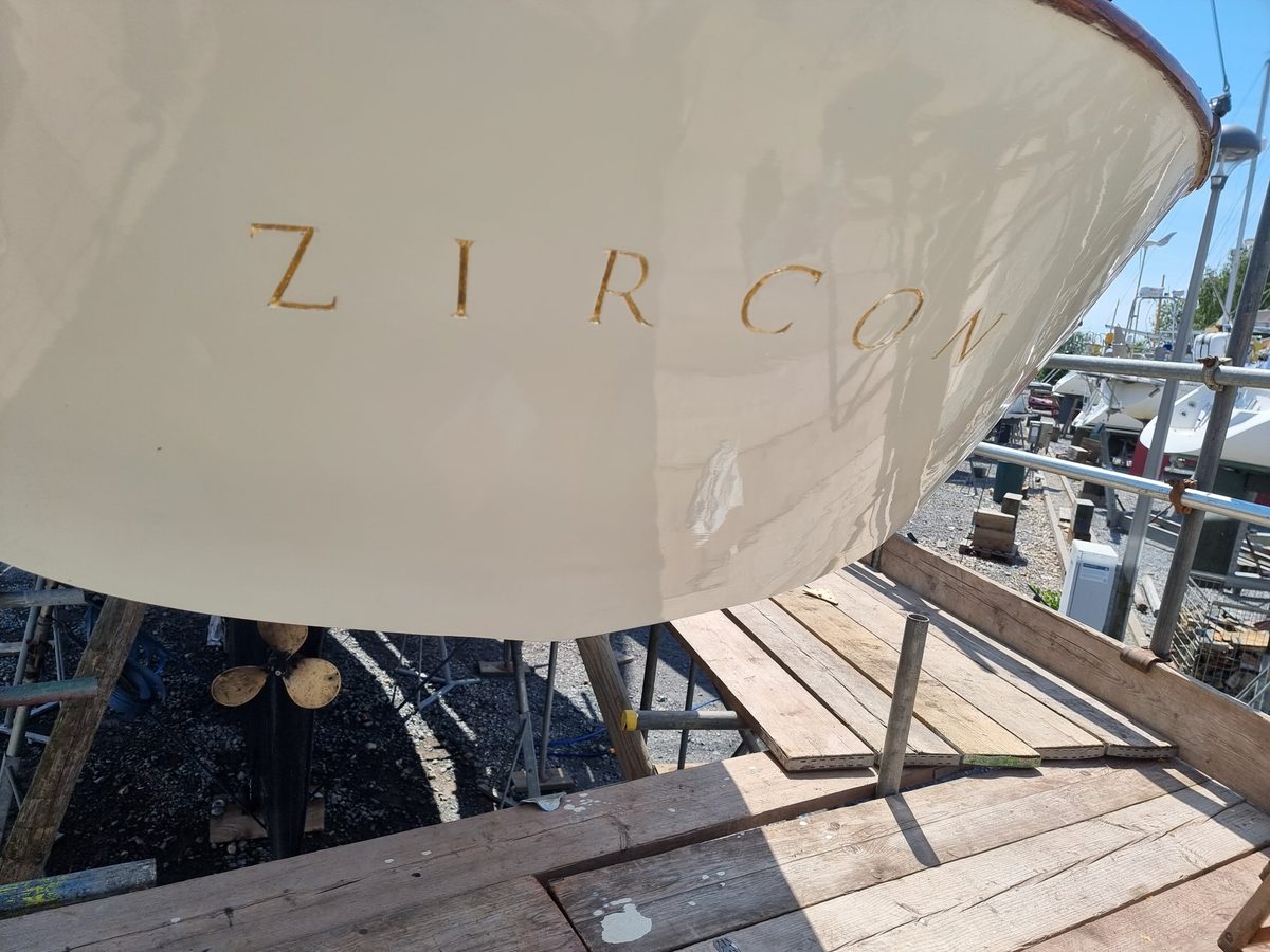 Zircon's name in gold leaf lettering across her glossy cream transom